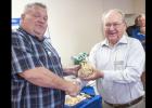 CCLP/DAVID MORRIS - Brian Hawkins, left, accepts a bag of money from Western Insurance president Tom Boren during the monthly Chamber of Commerce Mixer. Western Insurance recently celebrated 40 ears in the Copperas Cove community