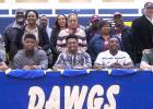CCLP/DAVID MORRIS - Copperas Cove football players, from left, Ra’Shaun Henry (Saint Francis - Pennsylvania), Josh Klenclo (Tyler Junior College), Antonio Lealiiee Texas A&M-Commerce), Shamad Lomax (New Mexco State) and J.P. Urquidez (Baylor) pose with family members during Wednesday’s signing ceremony in Bulldawg Gymnasium.