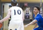 CCLP/TJ MAXWELL - Cove junior Neyland Block defends Lake Travis junior Ben Hoellwarth during the Dawgs’ 65-54 loss to the Cavs on Tuesday.