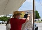 Kevin Marsh, director of the Copperas Cove Public Library, moves the moon across the sun on Monday afternoon to demonstrate the path of the total solar eclipse (Photo by Pamela Grant)