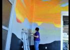 CCLP/LYNETTE SOWELL - Five Hills Art Guild mural project director Sheri Wilson works at blocking areas of the guild’s mural at the future Sutherlands Home Base store, set to open in March.