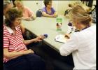CCLP/PAMELA GRANT - Jamie Moseley checks the blood pressure, oxygen, and pulse rate of Anita Dimmack at the free health screening at the Senior Citizen Center.