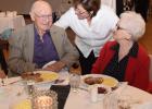 Elizabeth Hayden serves a German style dinner to John Hull and his wife, Shirley Hull, who were in attendance at Saturday’s event in MLK’s honor.