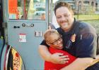 Cindy Williams gives hugs Monte Priest at Tuesday night’s National Night Out block party at Brookview Village. 