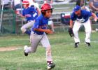 12U Cove Ranger’s Josiah Key charges towards first base as Cove Royals pitcher Austin Hilgenberg makes a play on the ball during their contest Monday as part of the District 4 tournament in.