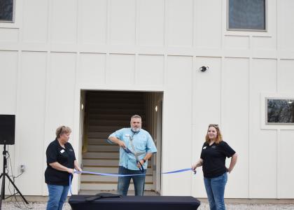 A 2024 ribbon cutting celebrates the expansion of Cove House Emergency Homeless Shelter.