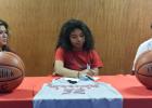 Copperas Cove senior guard Xylina Carlisle, center, with her parents Rose and Orlando Carlisle recently signed a letter of intent to play basketball for the Sul Ross Lady Lobos.