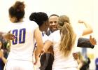 Copperas Cove head coach Eldridge McAdams celebrates with his players, from left, Mikayla Blount, Kenya Hanyes and Angel Mullen. The Lady Dawgs improved to 13-5 overall and 2-1 in district play with their 70-65 win over The Ellison Lady Eagles Friday at Bulldawg Gymnasium.