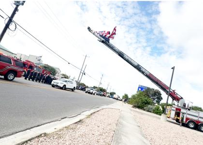 CCLP/LYNETTE SOWELL-STEVENS The prcesssion for Retired Deputy Fire Chief Mike Flaming passes in front of the Central Fire Station last. Friday morning. Fleming was remembered with a Celebration of Life service on Monday at Lea Ledger Auditorium.