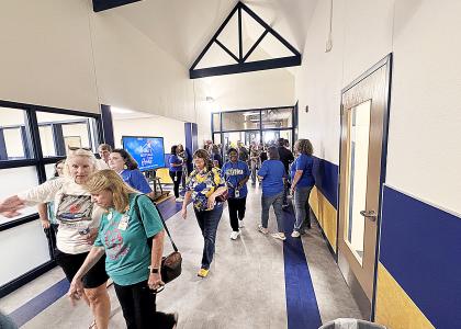 Community members, family, students and CCISD staff enter the newly reopened Williams/Ledger Elementary School after a ribbon cutting on Monday afternoon. 