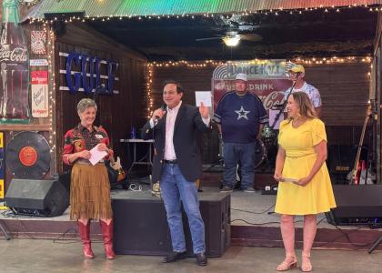 Steve Munisteri, senior advisor for the office of Governor Greg Abbott, speaks to the crowd at Boots & Bling.