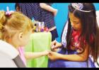 Natalie Perez, Preteen Miss Rabbit Fest, paints fingernails at the Pretty Princess Parlor at Saturday’s YMCA back to school party.