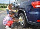 Stephanie Burkholder and Shannon Bryant wash a car at Saturday’s fundraiser for The Rainbow Room.