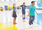 Second graders at Halstead Elementary do jumping jacks at Friday’s mathnasium.