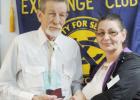 Cove Board Member Angela Fields presents Exchange Sunshine Home Apartments resident Michael Quick with the Senior Citizen of the Third Quarter Award. Quick was selected because of his volunteer work and assistance he offers other residents.