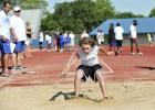 Nick Hooten lands in the sand pit as he competes during a summer track meet at Bulldawg Stadium. The summer track program kicksoff June 9.
