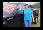 Malae Lucas holds the keys as she stands by the 2014 Ford F150 she won at Holy Family Catholic Church’s Fall Festival.