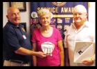 Mark Peterson, left, presents Francis and Rita Walker with the Proudly We Hail award for flying their flag.